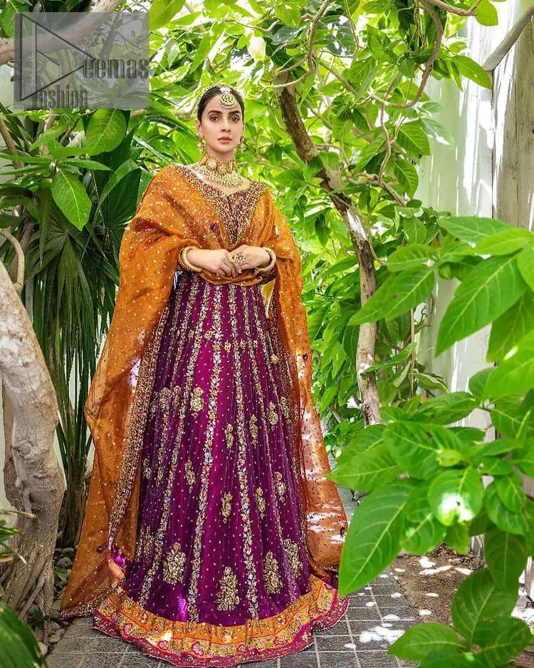 The outfit defines the true essence of allure with its spellbinding magenta hue and intricate details. The blouse is decorated