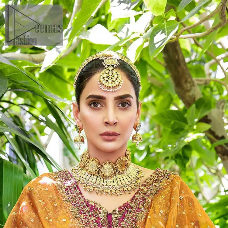 The outfit defines the true essence of allure with its spellbinding magenta hue and intricate details. The blouse is decorated