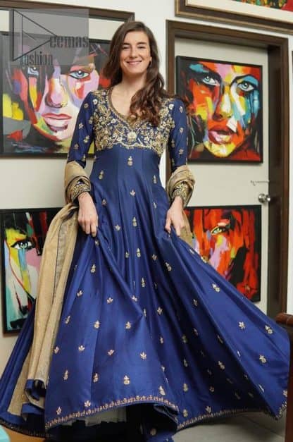 Hues of blues make a funky yet amazing pattern on amazing events. DeemasFashion introduces a navy blue outfit. Starting this article with a navy blue multiple panel frock which is ornamented with golden embroidery. The pattern of embroidery begins with the round neckline which is handsomely embellished with tilla, dabka, kora and Kundan. It is further prominent with full sleeves. The rest of the frock is decorated with floral motifs in a golden hue. The following frock comes with a golden dupatta to complete the admiring look on any day or night event. 