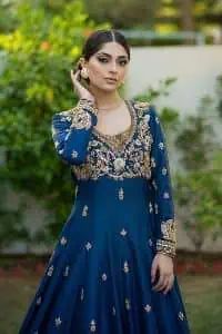 Hues of blues make a funky yet amazing pattern on amazing events. DeemasFashion introduces a navy blue outfit. Starting this article with a navy blue multiple panel frock which is ornamented with golden embroidery. The pattern of embroidery begins with the round neckline which is handsomely embellished with tilla, dabka, kora and Kundan. It is further prominent with full sleeves. The rest of the frock is decorated with floral motifs in a golden hue. The following frock comes with a golden dupatta to complete the admiring look on any day or night event. 