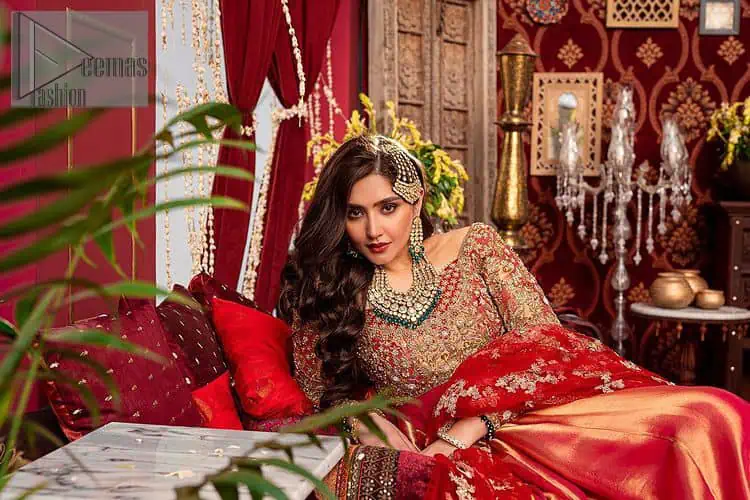 Bride love is in the air! DeemasFashion presents a red shirt rendered with golden embroidery and is enhanced with the magic of Resham, pearls, Sitara, tilla and dabka to complete the feeling of your Big Day. The shirt is emphasized with boat shape neckline and full sleeves to make your day super romantic. In addition to this, it is coordinated with red back train gharara which is intimately embellished with golden floral motifs as well. To finish this article, the last but not least piece comes that is the dupatta which is adorned with four sides heavy borders and sequins spray all over to explain the love of the bride.