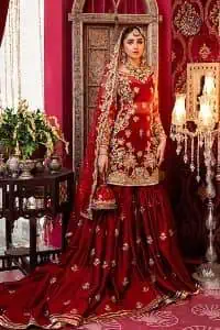 Bride love is in the air! DeemasFashion presents a red shirt rendered with golden embroidery and is enhanced with the magic of Resham, pearls, Sitara, tilla and dabka to complete the feeling of your Big Day. The shirt is emphasized with boat shape neckline and full sleeves to make your day super romantic. In addition to this, it is coordinated with red back train gharara which is intimately embellished with golden floral motifs as well. To finish this article, the last but not least piece comes that is the dupatta which is adorned with four sides heavy borders and sequins spray all over to explain the love of the bride.