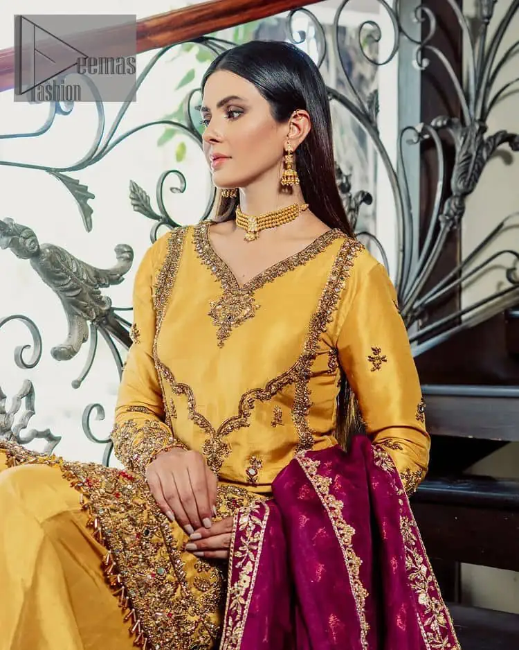 Yellow has the ability to take all the attention. Deemasfashion presents a yellow and pink outfit for your Mehandi. Starting this article with a yellow shirt that is handsomely decorated with golden embroidery and prominent with tilla, dabka, kora and zardozi to make your look super unique and perfect. Further, the following shirt is paired up with yellow straight trousers whose border is again rendered with golden embroidery. Complete this article with a magenta dupatta embellished with intimate border embroidery to gain all the attention of the event.