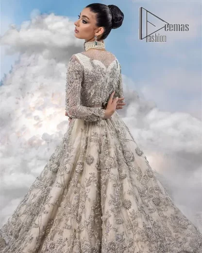 The mind wears the colours of the soul, as a beige of those of his master. Starting this nikah outfit with a beige frilled maxi which is laboriously hand-rendered with silver embroidery to fulfil the fairy dream of every bride. Furthermore, it is enhanced with tilla, dabka, kora and crystal which magnifies the beauty of this nikah outfit. The illusion neckline looks as amazing when comes with full sleeves as the moon with stars. The maxi of this nikah outfit is systemized with a lehenga in the same colour which is proof of uniqueness. Complete this nikah outfit with a dupatta in the same colour having a four-sided embellished border and sequins sprayed all over.    