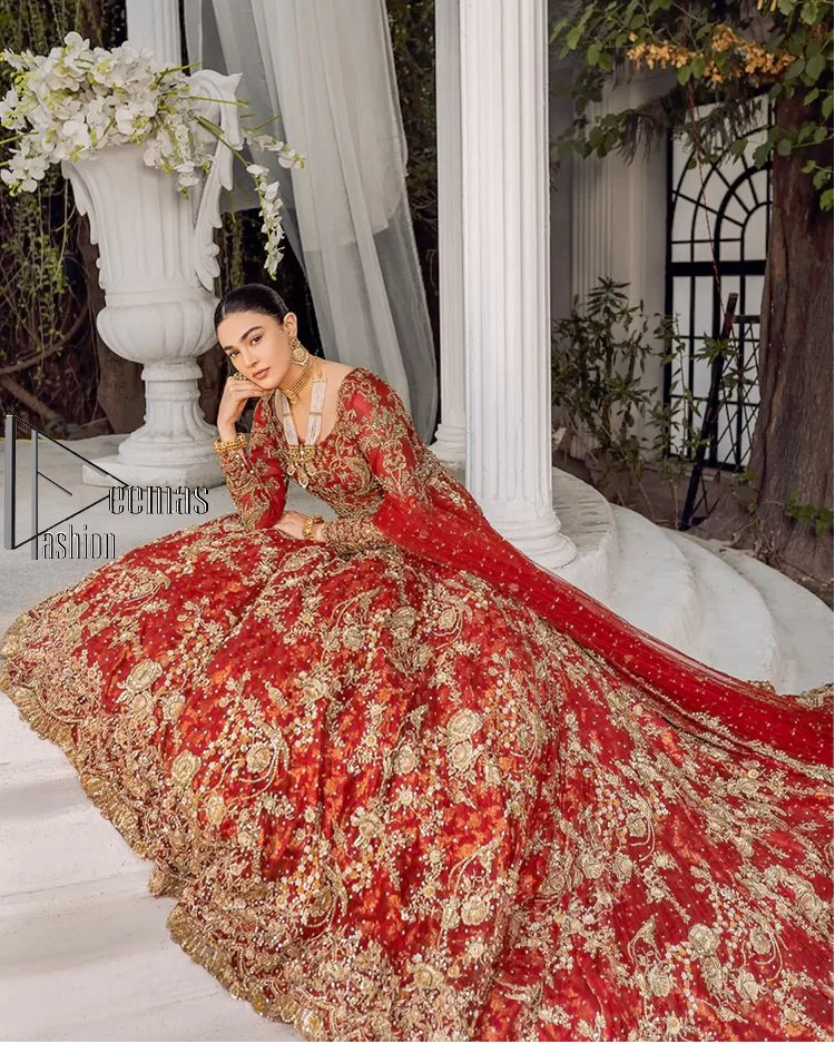 Feels just redish on your Big day to make your day lovely and romantic. DeemasFashion presents this Pakistani reception wear for you in bright red colour which begins with a flared back train maxi. The maxi is attractively and laboriously adorned with golden embroidery that enhances tilla,dabka, kora and Kundan. In addition to this, the boat shape neckline intensifies the beauty of this Pakistani reception wear when comes with full sleeves. The flared back train of the maxi is also heavily embellished. Complete this article with a dupatta in the same colour which is adorned with four-sided borders and tiny floral motifs, sequins spray all over to make you fresh on your Big day.
