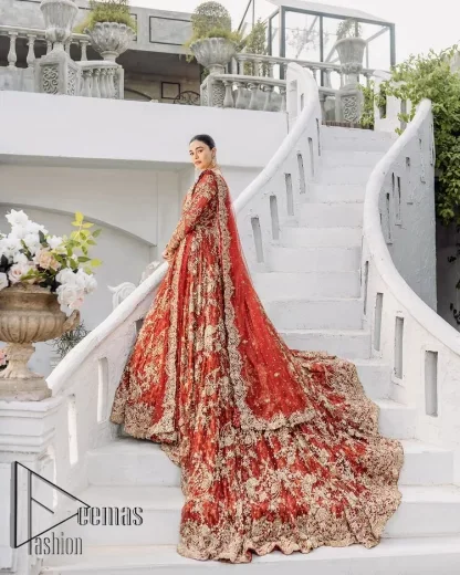 Feels just redish on your Big day to make your day lovely and romantic. DeemasFashion presents this Pakistani reception wear for you in bright red colour which begins with a flared back train maxi. The maxi is attractively and laboriously adorned with golden embroidery that enhances tilla,dabka, kora and Kundan. In addition to this, the boat shape neckline intensifies the beauty of this Pakistani reception wear when comes with full sleeves. The flared back train of the maxi is also heavily embellished. Complete this article with a dupatta in the same colour which is adorned with four-sided borders and tiny floral motifs, sequins spray all over to make you fresh on your Big day.