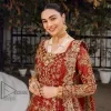 Feels just redish on your Big day to make your day lovely and romantic. DeemasFashion presents this Pakistani reception wear for you in bright red colour which begins with a flared back train maxi. The maxi is attractively and laboriously adorned with golden embroidery that enhances tilla,dabka, kora and Kundan. In addition to this, the boat shape neckline intensifies the beauty of this Pakistani reception wear when comes with full sleeves. The flared back train of the maxi is also heavily embellished. Complete this article with a dupatta in the same colour which is adorned with four-sided borders and tiny floral motifs, sequins spray all over to make you fresh on your Big day.