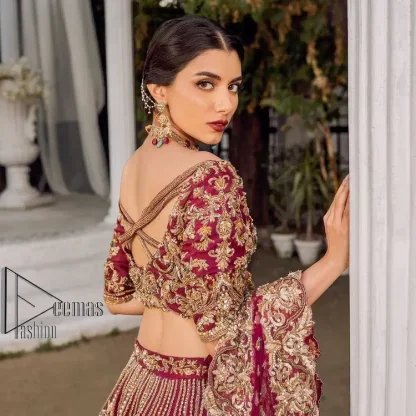 Make your day more lovely by wearing maroon colours. Maroon is just the star among all colours for the bride's Big day. So, DeemasFashion presents this maroon Pakistani reception outfit which begins with a traditional blouse that is meticulously adorned with light golden embroidery. Further, it is enhanced with tilla, dabka, kora and zardozi to make your day more remarkable. The three-quarter sleeves of the blouse add more beauty to this outfit. This Pakistani reception outfit is paired up with a can-can lehenga which is again heavily ornamented with light golden embroidery. Finish this article with a dupatta that is embellished with a four-sided border to fulfil your artistic look.