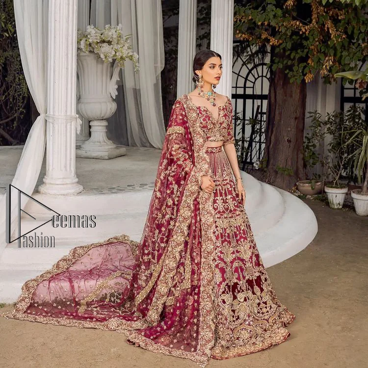 Make your day more lovely by wearing maroon colours. Maroon is just the star among all colours for the bride's Big day. So, DeemasFashion presents this maroon Pakistani reception outfit which begins with a traditional blouse that is meticulously adorned with light golden embroidery. Further, it is enhanced with tilla, dabka, kora and zardozi to make your day more remarkable. The three-quarter sleeves of the blouse add more beauty to this outfit. This Pakistani reception outfit is paired up with a can-can lehenga which is again heavily ornamented with light golden embroidery. Finish this article with a dupatta that is embellished with a four-sided border to fulfil your artistic look.