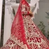 Marry someone who makes your heart shine. Wear what makes your soul shine. Introducing this Pakistani reception outfit which begins with a red blouse which is laboriously hand-rendered with silver embroidery to make your day super bright as silver colour. Further, it is highlighted with tilla, dabka, kora and crystal. The blouse of this Pakistani reception outfit is enhanced with boat shape neckline and three-quarter sleeves. The following blouse of the Pakistani reception outfit is systemized with a panelled lehenga in the same colour which is again heavily embellished. Complete this outfit with a frilled dupatta which is embellished with two-sided borders and sequins sprayed all over to make you shine.