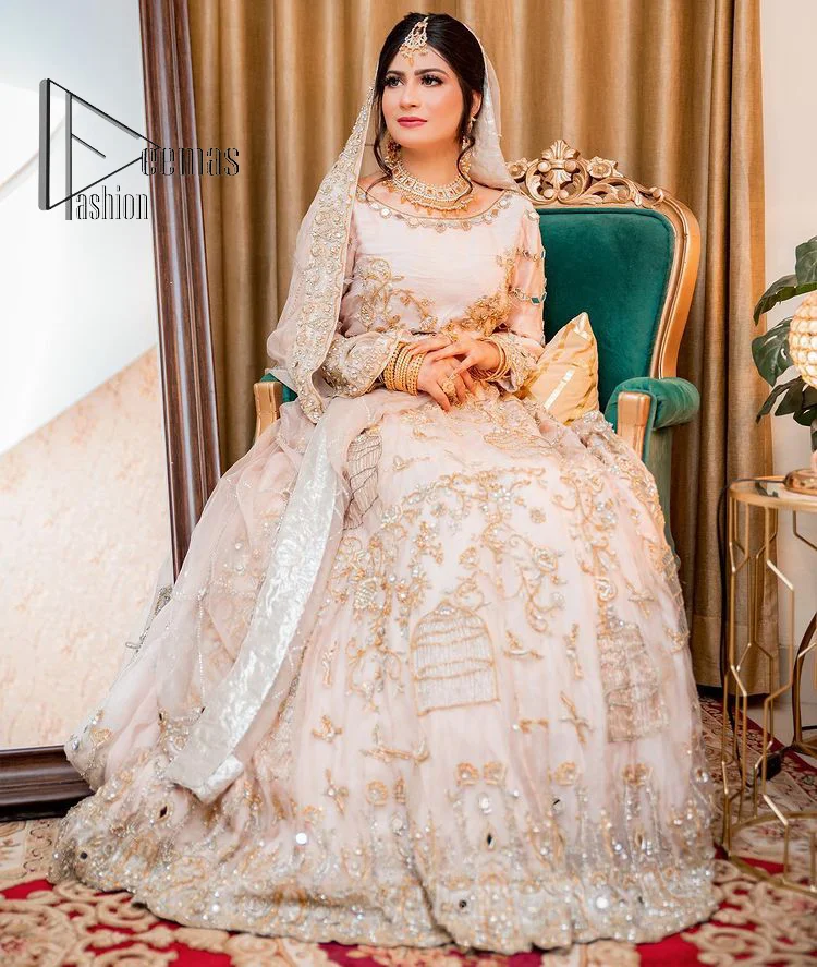 Confidence is wearing white on the big day. DeemasFashion presents the handsome and most attractive nikah outfit in white colour. Begin this nikah outfit with flared maxi which is beautifully decorated with light golden and silver embroidery involving kora, dabka, tilla and crystal to make your nikkah outfit super amazing. The round neckline of the nikah outfit laboriously comes with full sleeves. It is paired up with a dupatta in the same colour having a four-sided embellished border and sequin sprayed all over to increase your confidence with this nikah outfit.