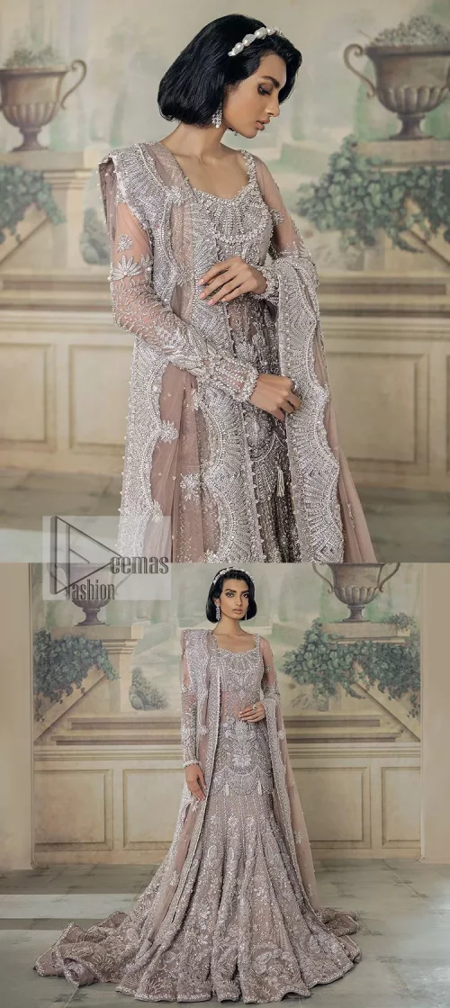 Luxurious canvas embodying grace and style! It is a well-crafted short shirt enhanced with silver embroidery accentuated with gleaming ornaments.