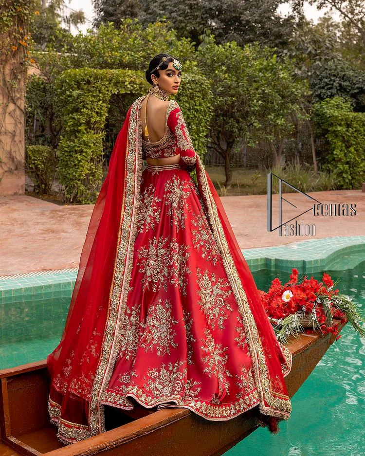 Nothing beats the luxury of bright red couture in reception. Our luxury bright red blouse is entirely hand-worked and finished with the fine material of golden embroidery which is self-explanatory of the uniqueness of the attire. It is further enhanced with tilla, dabka, kora and Sitara. The boat shape neckline also added engaging and attractive beauty to the outfit when comes to full sleeves. It is organized with flared lehenga to make your day super amazing and fulfil your dreamy romantic look. Complete this with a dupatta which is embellished with four-sided borders and sequins sprayed all over to beat the luxury of bright red.
