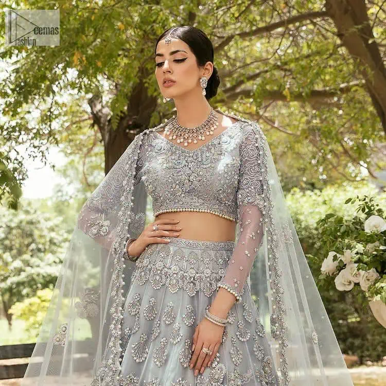 The magic of luxurious romantic outfits, giving you love at your Walima. The outfit defines the endless beauty of the immaculately produced pieces with intricate silver and golden embellishments, which are further magnified wth tilla, dabka, kora, Kundan and crystal. The full sleeve style of the blouse along with V shape neckline just gives you a unique way of artistic look. It is systemized with frilled lehenga which is heavily embellished with floral patterns to make your day more charming and delightful. Complete this article with a dupatta which is embellished with a four-sided border and ting floral motifs all over that are a dream of someone's special moment.