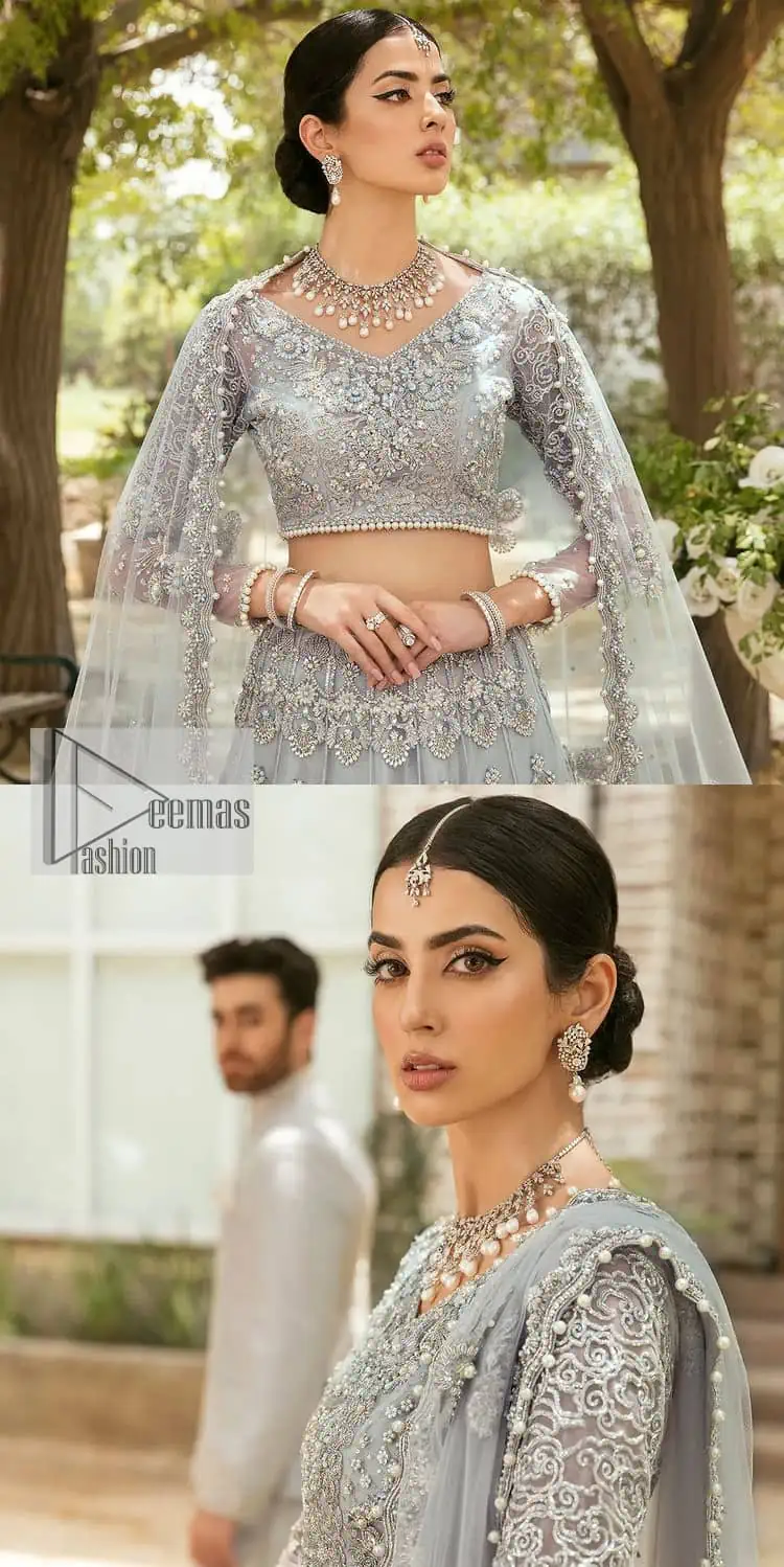 The magic of luxurious romantic outfits, giving you love at your Walima. The outfit defines the endless beauty of the immaculately produced pieces with intricate silver and golden embellishments, which are further magnified wth tilla, dabka, kora, Kundan and crystal. The full sleeve style of the blouse along with V shape neckline just gives you a unique way of artistic look. It is systemized with frilled lehenga which is heavily embellished with floral patterns to make your day more charming and delightful. Complete this article with a dupatta which is embellished with a four-sided border and ting floral motifs all over that are a dream of someone's special moment.