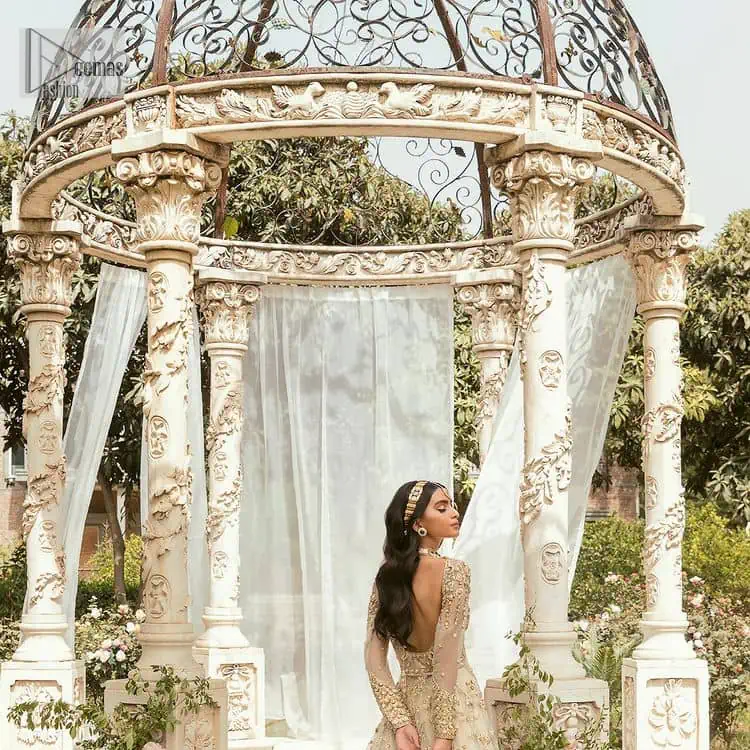 Mark your Nikah day in a calendar as a special one with this marvellous outfit. DeemasFashion presents this outfit in light fawn colour which begins with a back train scalloped maxi. The following maxi is sumptuously embellished with a golden embroidery which is further intensified with tilla, dabka, naqshi, Resham and zardozi. The sweetheart neckline of the maxi is heavily embellished and looks romantic when comes with full sleeves style. It is handsomely paired up with a lehenga in the same colour which is so plain to balance the look of the outfit. Finish this article with a scalloped dupatta which is embellished with four-sided borders and sequins sprayed all over to make your day more magical.