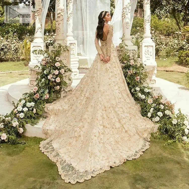 Mark your Nikah day in a calendar as a special one with this marvellous outfit. DeemasFashion presents this outfit in light fawn colour which begins with a back train scalloped maxi. The following maxi is sumptuously embellished with a golden embroidery which is further intensified with tilla, dabka, naqshi, Resham and zardozi. The sweetheart neckline of the maxi is heavily embellished and looks romantic when comes with full sleeves style. It is handsomely paired up with a lehenga in the same colour which is so plain to balance the look of the outfit. Finish this article with a scalloped dupatta which is embellished with four-sided borders and sequins sprayed all over to make your day more magical.