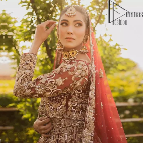 Love is in the air. A maroon blouse in maroon colour is hand-rendered in gold and is enhanced with naqshi,