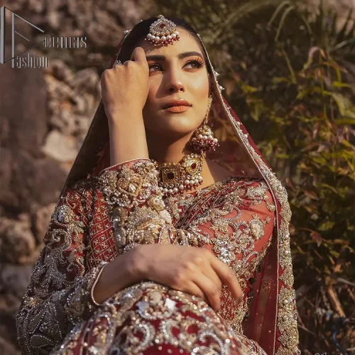 Love is in the air. A maroon blouse in maroon colour is hand-rendered in gold and is enhanced with naqshi,