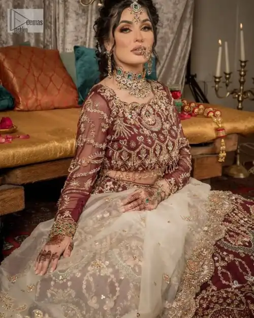 Take your style up a few notches in this elegant reception piece. A pure organza maroon fluffy lehnga is beautifully