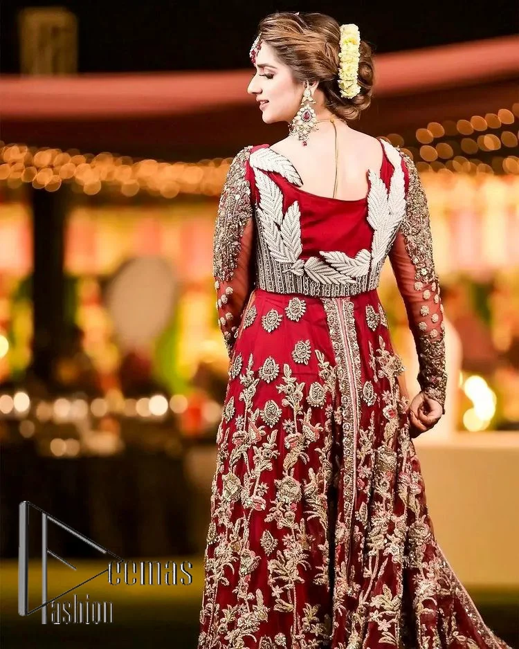 The magic of luxurious romantic silhouettes, giving out love and letting it come in. A maroon frilled maxi that is purely designed for your reception and hand-crafted with Sitara, pearls, tilla , and dabka along with the magic of zardozi. Further, it is handsomely ornamented with multiple embroideries to steal everyone's heart. The round shape neckline enhances the beauty of the outfit when comes with full sleeves to make you the star of the show. The front open style of the maxi truly makes you a unique bride of all eras.