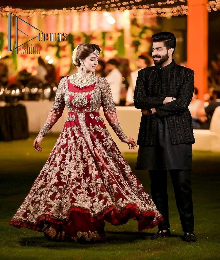 The magic of luxurious romantic silhouettes, giving out love and letting it come in. A maroon frilled maxi that is purely designed for your reception and hand-crafted with Sitara, pearls, tilla , and dabka along with the magic of zardozi. Further, it is handsomely ornamented with multiple embroideries to steal everyone's heart. The round shape neckline enhances the beauty of the outfit when comes with full sleeves to make you the star of the show. The front open style of the maxi truly makes you a unique bride of all eras.