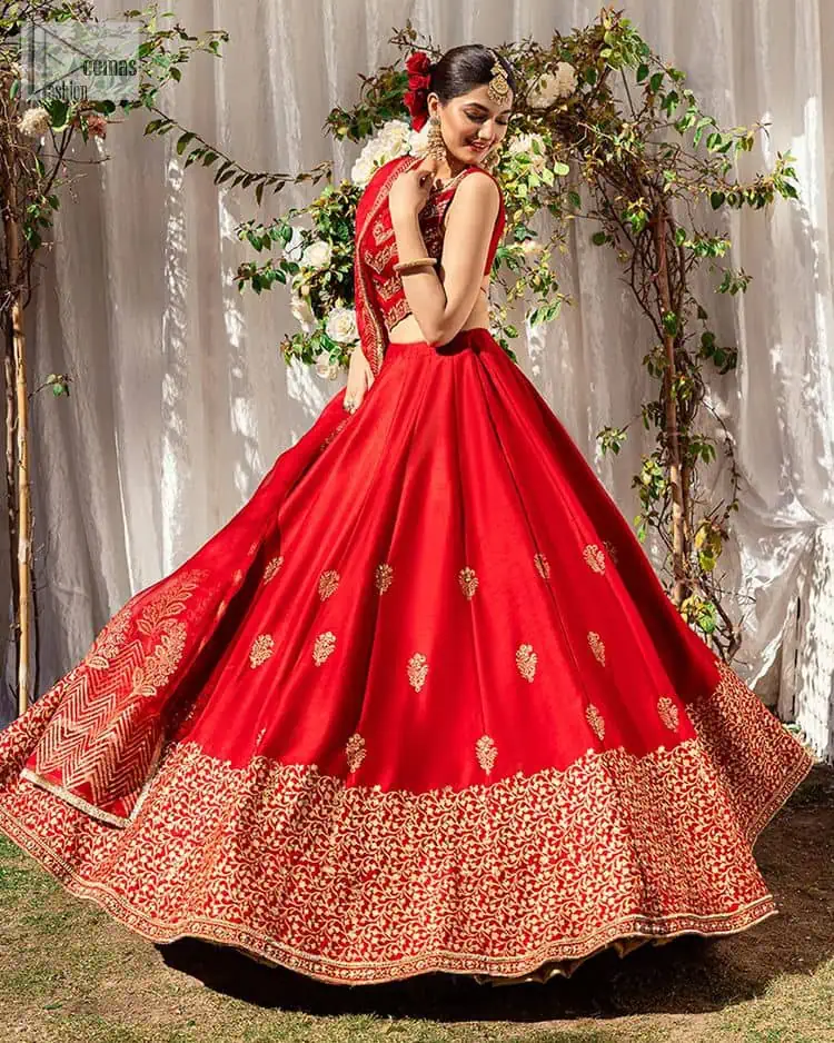 Master of artists who are the secret keepers of the canvas made the perfect shade of red for you to wear at your reception. A pure organza canvas of blouse, dipped in the richest shade of red, is adorned with dabka, sequins, tilla, kora and the magic of Resham. The following blouse is further magnified with golden embroidery with the highest attention to detail. The Round shape neckline of the blouse gives so romantic look when comes with a sleeveless style. It is paired u with flared and fluffy lehenga in silk whose bottom is heavily embellished. Complete this outfit with an organza dupatta framed with four-sided borders to be the star of the show.