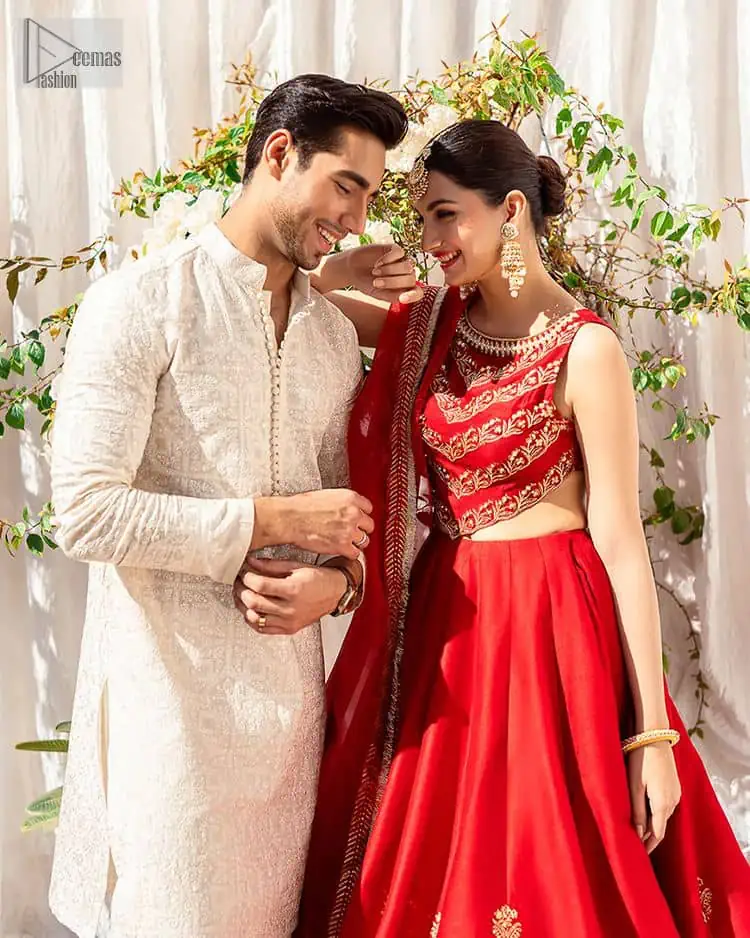 Master of artists who are the secret keepers of the canvas made the perfect shade of red for you to wear at your reception. A pure organza canvas of blouse, dipped in the richest shade of red, is adorned with dabka, sequins, tilla, kora and the magic of Resham. The following blouse is further magnified with golden embroidery with the highest attention to detail. The Round shape neckline of the blouse gives so romantic look when comes with a sleeveless style. It is paired u with flared and fluffy lehenga in silk whose bottom is heavily embellished. Complete this outfit with an organza dupatta framed with four-sided borders to be the star of the show.