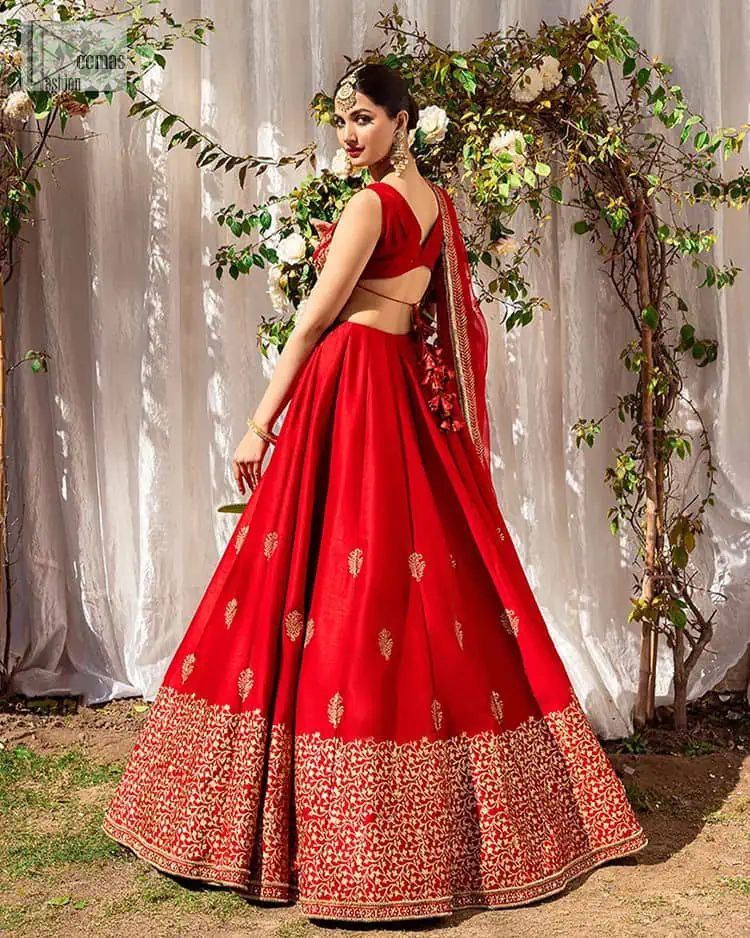 Master of artists who are the secret keepers of the canvas made the perfect shade of red for you to wear at your reception. A pure organza canvas of blouse, dipped in the richest shade of red, is adorned with dabka, sequins, tilla, kora and the magic of Resham. The following blouse is further magnified with golden embroidery with the highest attention to detail. The Round shape neckline of the blouse gives so romantic look when comes with a sleeveless style. It is paired u with flared and fluffy lehenga in silk whose bottom is heavily embellished. Complete this outfit with an organza dupatta framed with four-sided borders to be the star of the show.