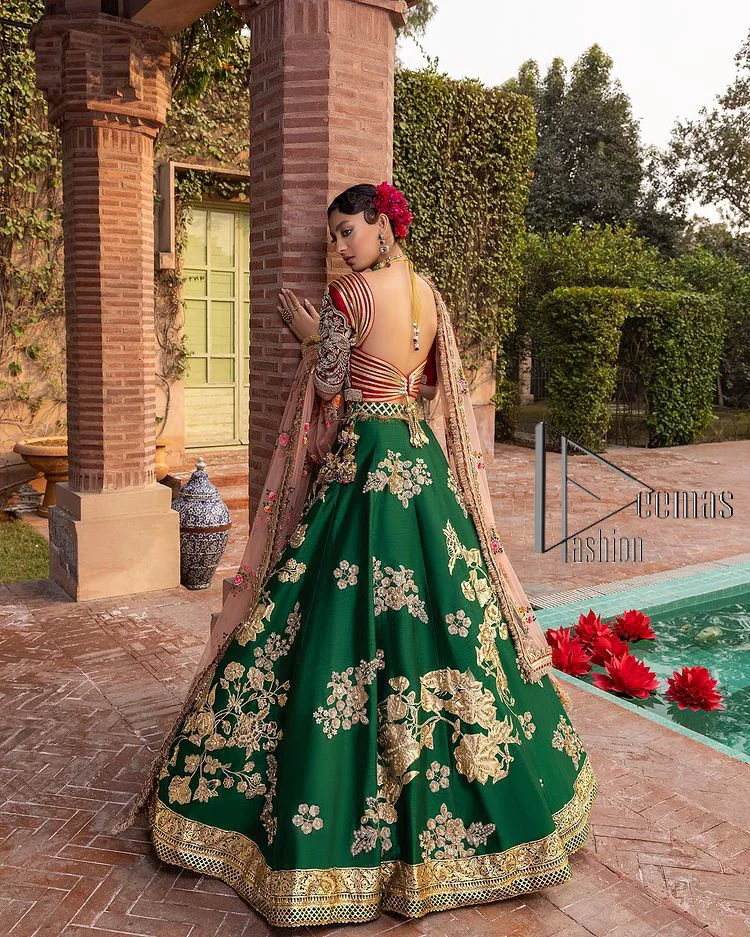 A combination of red and green are here to win hearts at your Mehndi. The attractive lehenga in green colour is hand-rendered with golden embroidery and enhanced with tilla, dabka, kora and zardozi. The floral pattern of the lehenga is followed by attractive border embroidery. It is paired up with a red blouse choli which is beautifully embellished and enhanced with V shape neckline. Further, the half sleeves style of the blouse also added beauty to this outfit. Finish this outfit with a dupatta which is ornamented with four-sided borders and floral motifs all over.