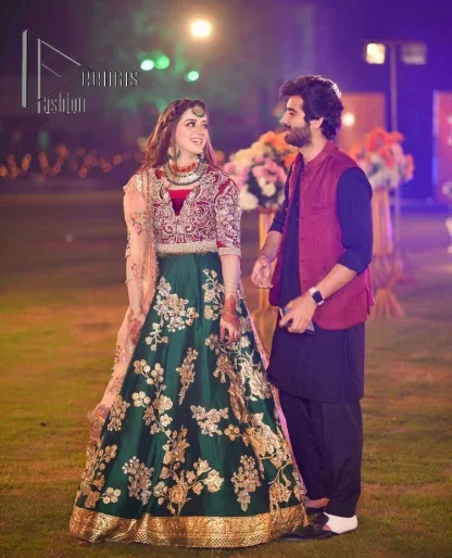 A combination of red and green are here to win hearts at your Mehndi. The attractive lehenga in green colour is hand-rendered with golden embroidery and enhanced with tilla, dabka, kora and zardozi. The floral pattern of the lehenga is followed by attractive border embroidery. It is paired up with a red blouse choli which is beautifully embellished and enhanced with V shape neckline. Further, the half sleeves style of the blouse also added beauty to this outfit. Finish this outfit with a dupatta which is ornamented with four-sided borders and floral motifs all over.