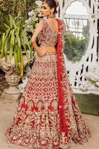 Red halter Neck Blouse with Lehenga and Dupatta. Further, the lehenga of this outfit is also adorned with heavy embroidery to boost your big day with love and emotions.