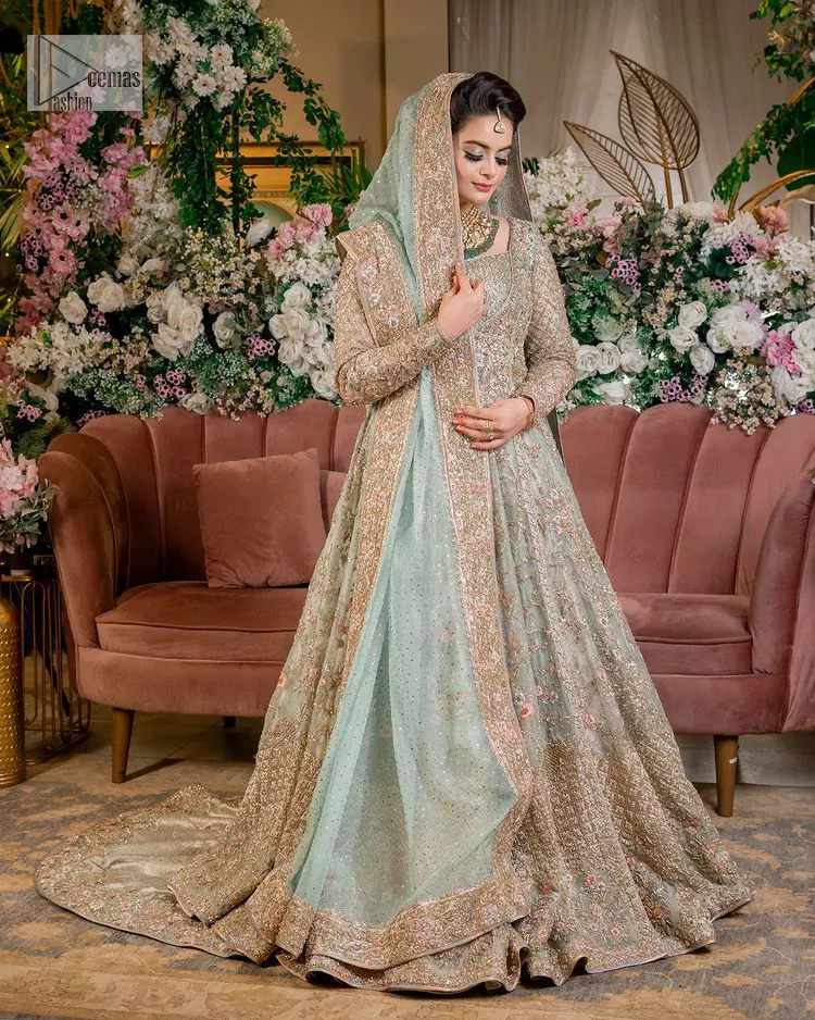 Let your outfit define your Nikah day. DeemasFashion presents this outfit in aqua colour to win everyone's hearts at the very first glance. The maxi is decorated with multiple colour embroidery which is further intensified with tilla dabka, kora, Kundan and the real magic of zardozi. The square neckline of the following maxi steals the spotlight of the event. In addition to this, the style of the full sleeves gives you your dreamy appearance. It is systemized with back train lehenga which is also embellished with embroidery to make your day. The overall charm of maxi and Lehenga is enhanced when paired with a delicate and diaphanous dupatta, framed with four-sided borders and sequins sprayed all over.