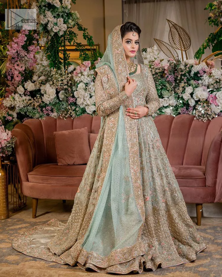 Let your outfit define your Nikah day. DeemasFashion presents this outfit in aqua colour to win everyone's hearts at the very first glance. The maxi is decorated with multiple colour embroidery which is further intensified with tilla dabka, kora, Kundan and the real magic of zardozi. The square neckline of the following maxi steals the spotlight of the event. In addition to this, the style of the full sleeves gives you your dreamy appearance. It is systemized with back train lehenga which is also embellished with embroidery to make your day. The overall charm of maxi and Lehenga is enhanced when paired with a delicate and diaphanous dupatta, framed with four-sided borders and sequins sprayed all over.