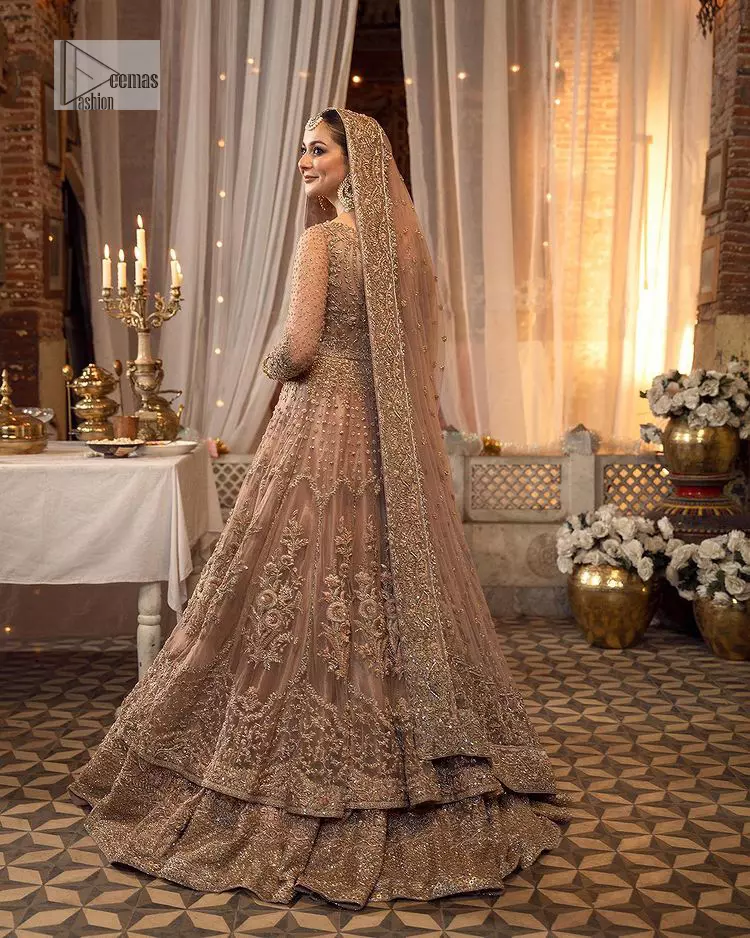 Regal and Charismatic – This is all the outfit is about! A desirable beige lehenga and choli are entirely heavily embroidered with silver colour and embellished with sequins, tilla, naqshi, Zardozi and Dabka. Its stunning heavily embellished blouse has full sleeves and the blouse consists of V shape neckline. It is coordinated with flared lehenga which is adorned with beautiful embroidery to make this walima wear balance. Finish this with a dupatta that has silver sequin and tiny floral motifs all over. The dupatta is framed with a four-sided embellished border to make this masterpiece unique and attractive.
