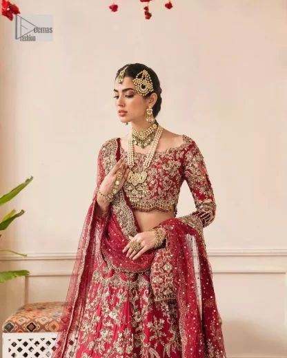 This outfit is a stand-out look for the Pakistani reception, this ensemble consists of a bright red-hued lehenga choli. This light golden embroidery is done with dense handsome work with the detailing of tilla, dabka, kora, zardozi and stone. The boat shape neckline of the following scalloped blouse intensifies the overall beauty of the outfit. Further, the beautiful floral patterns on three-quarter sleeves make this blouse super charming and ten times attractive. It is teamed up with can-can lehenga in the same colour that is ideal for the brides who want to be a queen on her Bug day. The outfit is paired with a dupatta heavily embellished all around the border, with a centre spray of sequins.