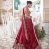 Keep it dreamy and classic with the best DeemasFashion reception wear! The handsome deep red outfit with blouse and lehenga is gracefully embellished with silver embroidery that gives you a head-turning appearance on the wedding day. The blouse is enhanced with tilla, dabka, kora, Kundan and crystals. The round neckline of the blouse makes this glamorous attire an epitome of royalty and grace. Luxury designs on half sleeves add super beauty to the outfit. It is organized with a lehenga adorned with embroidery to make your day charming. Finish this outfit with a dupatta embellished with four-sided borders and which is sprinkled with sequins all over.
