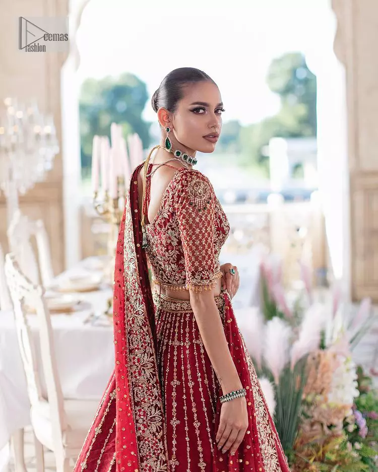 Keep it dreamy and classic with the best DeemasFashion reception wear! The handsome deep red outfit with blouse and lehenga is gracefully embellished with silver embroidery that gives you a head-turning appearance on the wedding day. The blouse is enhanced with tilla, dabka, kora, Kundan and crystals. The round neckline of the blouse makes this glamorous attire an epitome of royalty and grace. Luxury designs on half sleeves add super beauty to the outfit. It is organized with a lehenga adorned with embroidery to make your day charming. Finish this outfit with a dupatta embellished with four-sided borders and which is sprinkled with sequins all over.
