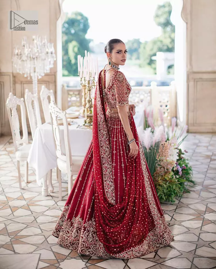 Keep it dreamy and classic with the best DeemasFashion reception wear! The handsome deep red outfit with blouse and lehenga is gracefully embellished with silver embroidery that gives you a head-turning appearance on the wedding day. The blouse is enhanced with tilla, dabka, kora, Kundan and crystals. The round neckline of the blouse makes this glamorous attire an epitome of royalty and grace. Luxury designs on half sleeves add super beauty to the outfit. It is organized with a lehenga adorned with embroidery to make your day charming. Finish this outfit with a dupatta embellished with four-sided borders and which is sprinkled with sequins all over.
