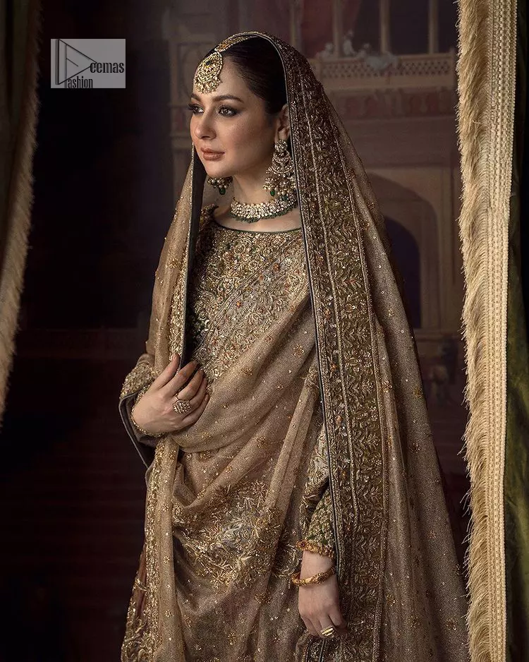 This alluring outfit is surely any girl’s dream. The hazel blouse is a magnificent choice which is ornamented with golden embroidery that wins everyone’s hearts at the very first glance. It is further intensified with tilla, dabka, kora, Kundan and stones. Hand-crafted details on the full sleeves of this beautiful nikah dress make it the epitome of beauty. It is coordinated with a lehenga which is decorated with the finest details that are your first priority for the wedding. The lehenga has a huge flare to fulfil the dreamy look. Complete this article with a dupatta that is adorned with four-sided embellished borders and sparkling sequins to make your day.
