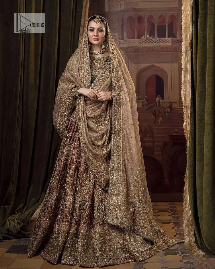 This alluring outfit is surely any girl’s dream. The hazel blouse is a magnificent choice which is ornamented with golden embroidery that wins everyone’s hearts at the very first glance. It is further intensified with tilla, dabka, kora, Kundan and stones. Hand-crafted details on the full sleeves of this beautiful nikah dress make it the epitome of beauty. It is coordinated with a lehenga which is decorated with the finest details that are your first priority for the wedding. The lehenga has a huge flare to fulfil the dreamy look. Complete this article with a dupatta that is adorned with four-sided embellished borders and sparkling sequins to make your day.

