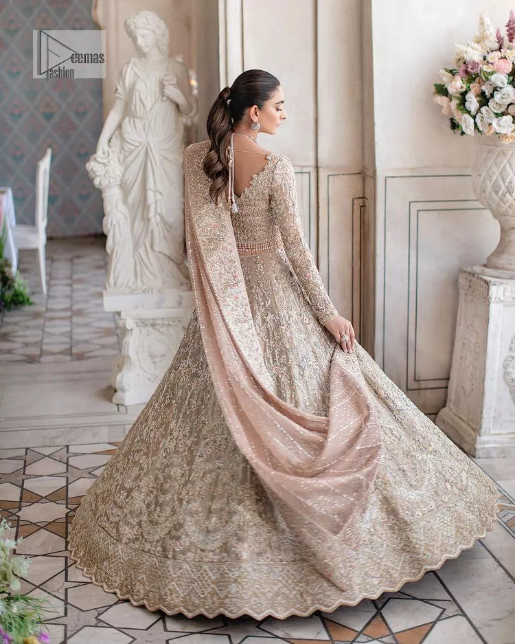 Carry the style that is your dream on your Nikah day with this classy article! A beautiful blouse in nude ivory colour is a perfect choice to pair with Lehenga. The blouse choli is emblazoned with silver embroidery and floral designs. Hand-crafted details of tilla, dabka, kora, Kundan and crystals make this choli a ravishing masterpiece. The boat shape neckline is a perfect choice to make this article super amazing. Further, the following blouse is maintain a balancing look of the bride with its full sleeves. It is handsomely systemized with a scalloped lehenga that is heavily adorned to win everyone’s hearts at the very first glance with its charm and elegance. Finish this article with a dupatta its surface sprayed with sequin and beautifully framed by a heavily embellished floral border that is a perfect choice
