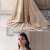 Ooze beauty and elegance in this simple yet amazing ensemble. This walima outfit in the off-white colour is a  magnificent look emblazoned with beautiful light golden embroidery which is further enhanced with tilla, dabka, kora, Kundan and the real magic of thread. The square neckline and full sleeves are unique in style and have classy look and perfect choice for the traditional bride. It is paired up with a lehenga which is adorned with beautiful embroidery. Father, the lehenga has a back-train to make this outfit lovely. Complete this with a dupatta framed with four-sided borders and sequins sprayed all over to add extra glam to this masterpiece.