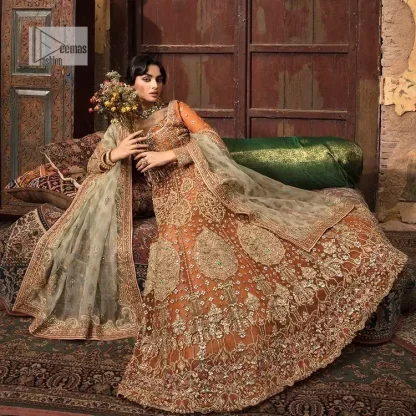 Let your dreams be your wings as your mehndi outfit. This rust heavy maxi features thoughtfully placed bold motifs all over and each motif is crafted using tilla, dabka, koran, Resham and Zardozi techniques. It is further enhanced with golden embroidery. The V shape neckline adds more beauty to the outfit when comes with embellished full sleeves. The beautiful outfit achieves the final ravishing look when paired with a delicate dupatta. The borders of this dupatta are heavily adorned with embroidery that gives a slaying touch to the whole attire.
