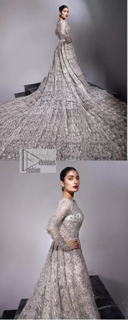 The trend of the back trains is still going strong as nikah wear - Here is the perfect one! This beautiful silver maxi is heavily embellished with silver embroidery. The gorgeous work of pearls, dabka, kora, Kundan and silver stones enhance the overall glamour of this maxi. The extraordinary design of the jewel neckline is completely embellished with silver stones and pearls embroidery combinations. The silver stones touch-up increases the looks of the beautiful gown with long tails that gives everlasting impact and at the bottom is the double flare. The full sleeves of the maxi are the lavishing style that any bride can wear on her big day.