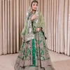 Dive into the world of ultimate allurement with this exquisitely embellished Mehndi outfit that depicts intricate glam with an elegant statement detailing. The maxi in teal green colour is heavily adorned with silver embroidery which involves tilla, dabka, kora, Kundan and the real magic of Zardozi. Further, the high neckline and full sleeves add extra glamour to this outfit. It is organized with magnificent lehenga in the same colour emblazoned with intricate gleaming embroidery which enhances the charm of this Dress. The tiny floral motifs also spread on the lehenga. Complete this article with a dupatta framed with four-sided borders and tiny floral motifs all over to make your day charming.