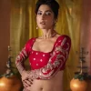 We are Introducing a wine red blouse and lehenga to our wide range of charming bridal dresses. The Pakistani reception Lehenga is an amalgamation of contemporary and traditional art which is decorated with golden embroidery. The embroidery is further enhanced with tilla, dabka, kora, Kundan and detailing of zardozi. It is paired up with a wine red blouse which is adorned with tiny floral motifs. The full sleeves of the blouse are heavily embellished to increase the beauty of the outfit. Further, the square neckline makes this blouse a unique masterpiece. Finish this with a dupatta with a four-sided embellished border and floral motifs all over.