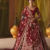 We are Introducing a wine red blouse and lehenga to our wide range of charming bridal dresses. The Pakistani reception Lehenga is an amalgamation of contemporary and traditional art which is decorated with golden embroidery. The embroidery is further enhanced with tilla, dabka, kora, Kundan and detailing of zardozi. It is paired up with a wine red blouse which is adorned with tiny floral motifs. The full sleeves of the blouse are heavily embellished to increase the beauty of the outfit. Further, the square neckline makes this blouse a unique masterpiece. Finish this with a dupatta with a four-sided embellished border and floral motifs all over.