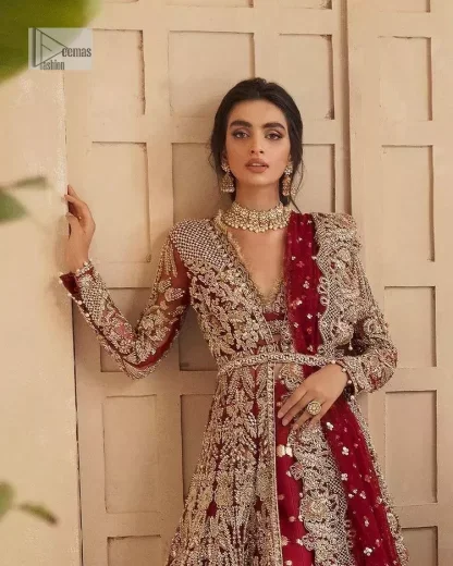 Classic and eye-catching! Made for stylish brides.  This reception wear in the bright red shade comes in a stunning open style and is hand-embellished with tilla,dabka, kora, Kundan and Zardozi details. The golden embroidery gives a royal touch to the dress. The V shape neckline gives you a dreamy appearance on the most important day of your life. Intricate designs and hand-crafted embellishments on full sleeves also make a look. It is systemized with a lehenga which has a huge flare and is adorned with embroidery. Complete this article with a dupatta framed with four-sided borders that is a perfect choice.