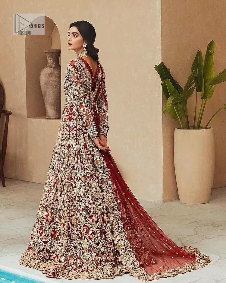 Classic and eye-catching! Made for stylish brides.  This reception wear in the bright red shade comes in a stunning open style and is hand-embellished with tilla,dabka, kora, Kundan and Zardozi details. The golden embroidery gives a royal touch to the dress. The V shape neckline gives you a dreamy appearance on the most important day of your life. Intricate designs and hand-crafted embellishments on full sleeves also make a look. It is systemized with a lehenga which has a huge flare and is adorned with embroidery. Complete this article with a dupatta framed with four-sided borders that is a perfect choice.
